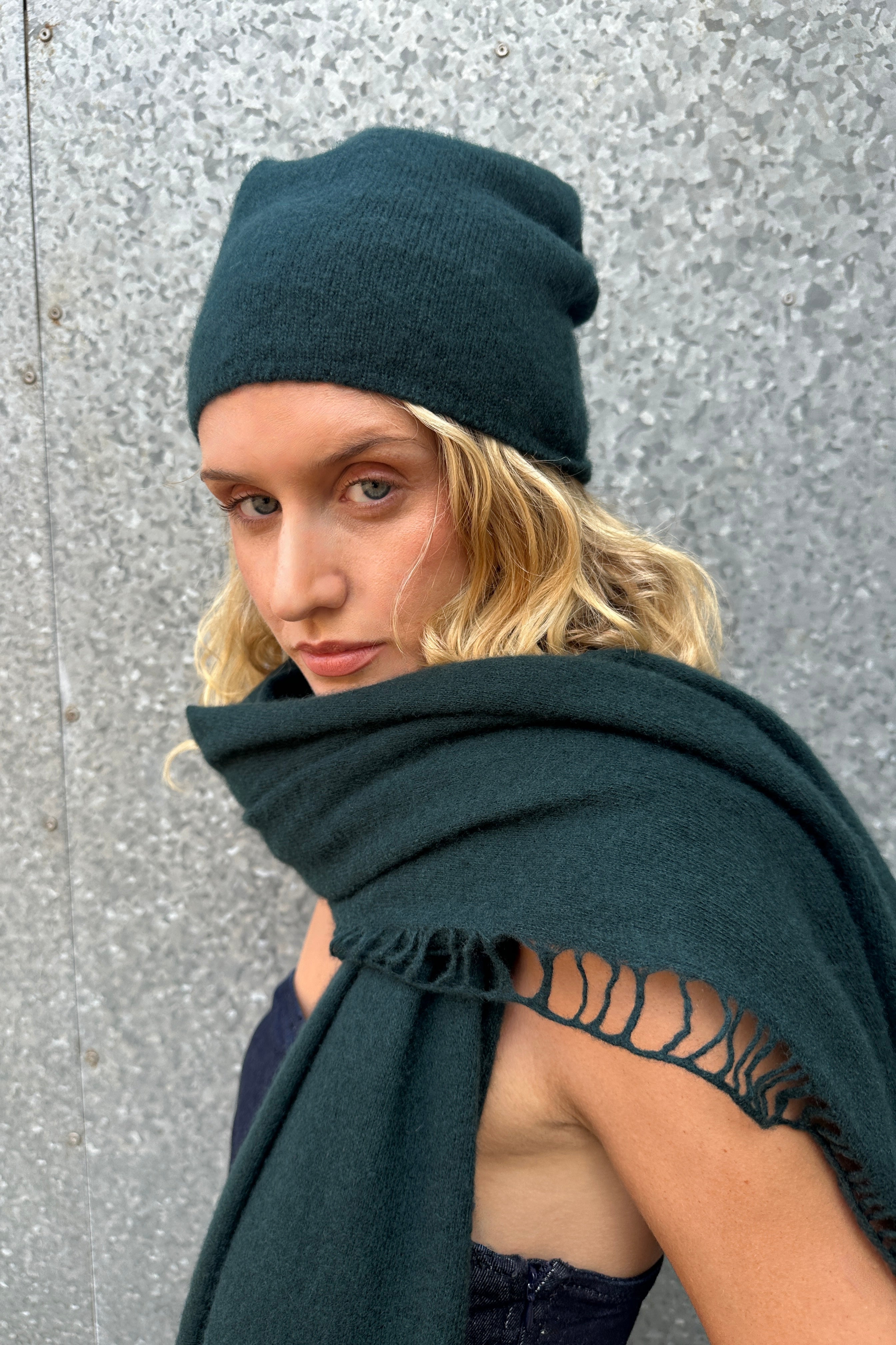 model wearing dark green cashmere scarf and hat close up