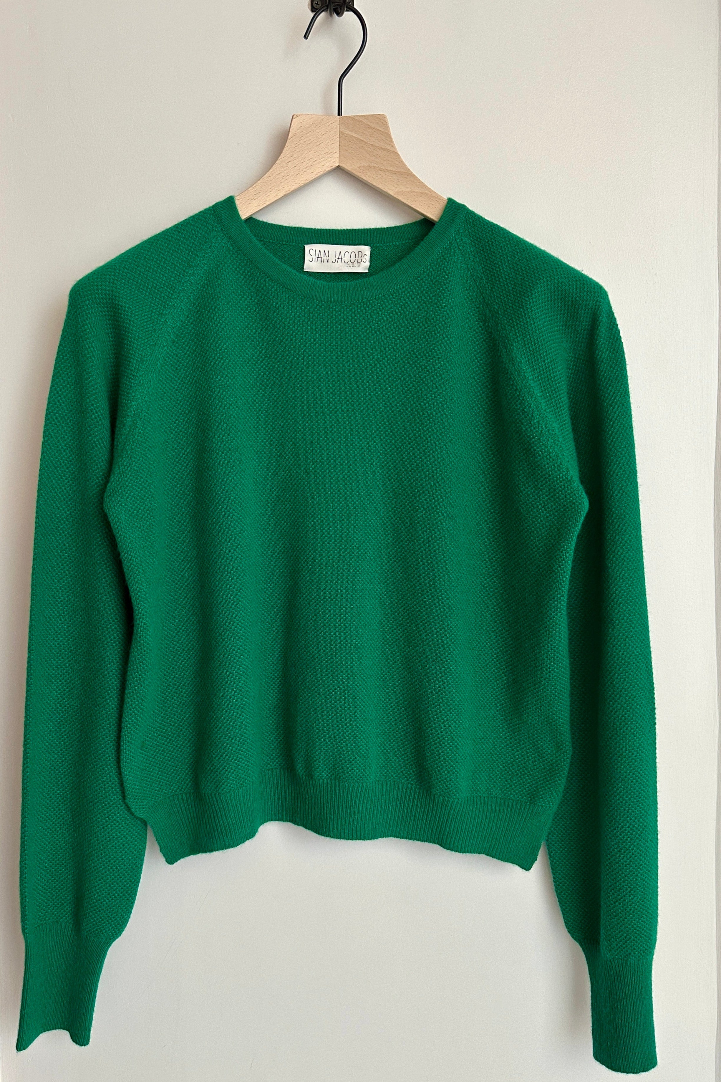 bonnie round neck crew neck cashmere waffle knit sweater in green on hanger