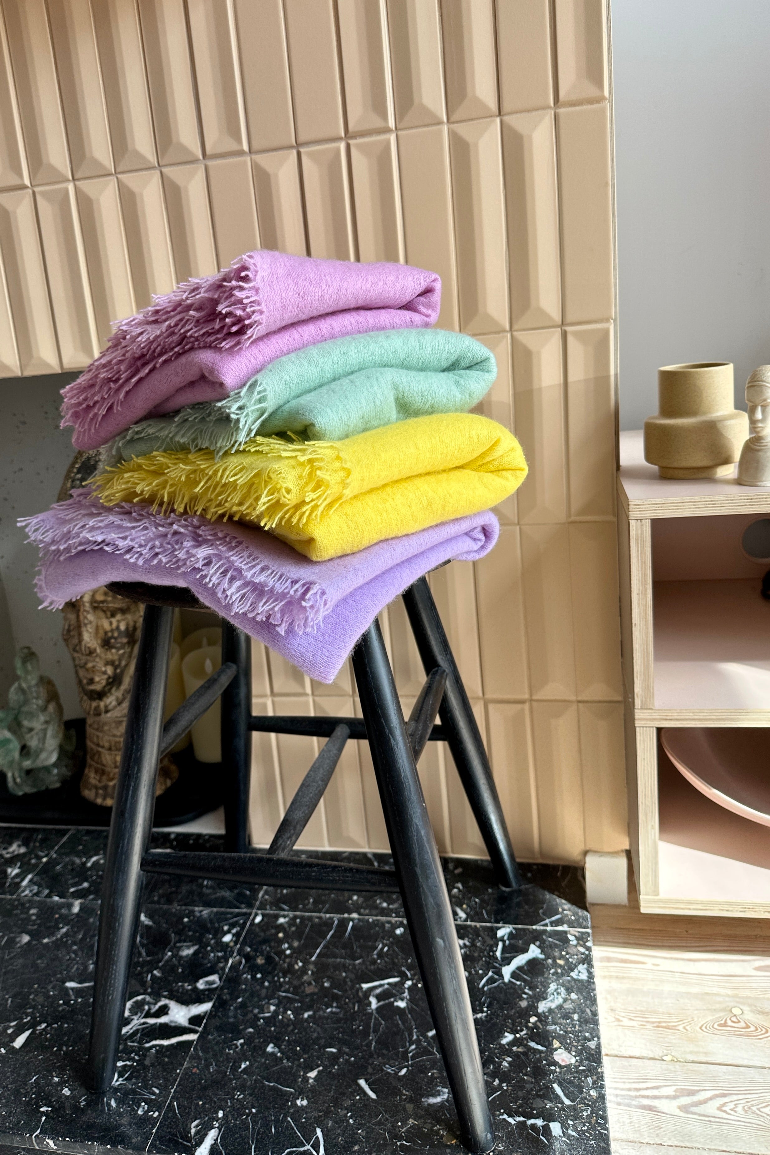 bundle of Eighty scarves on a stool