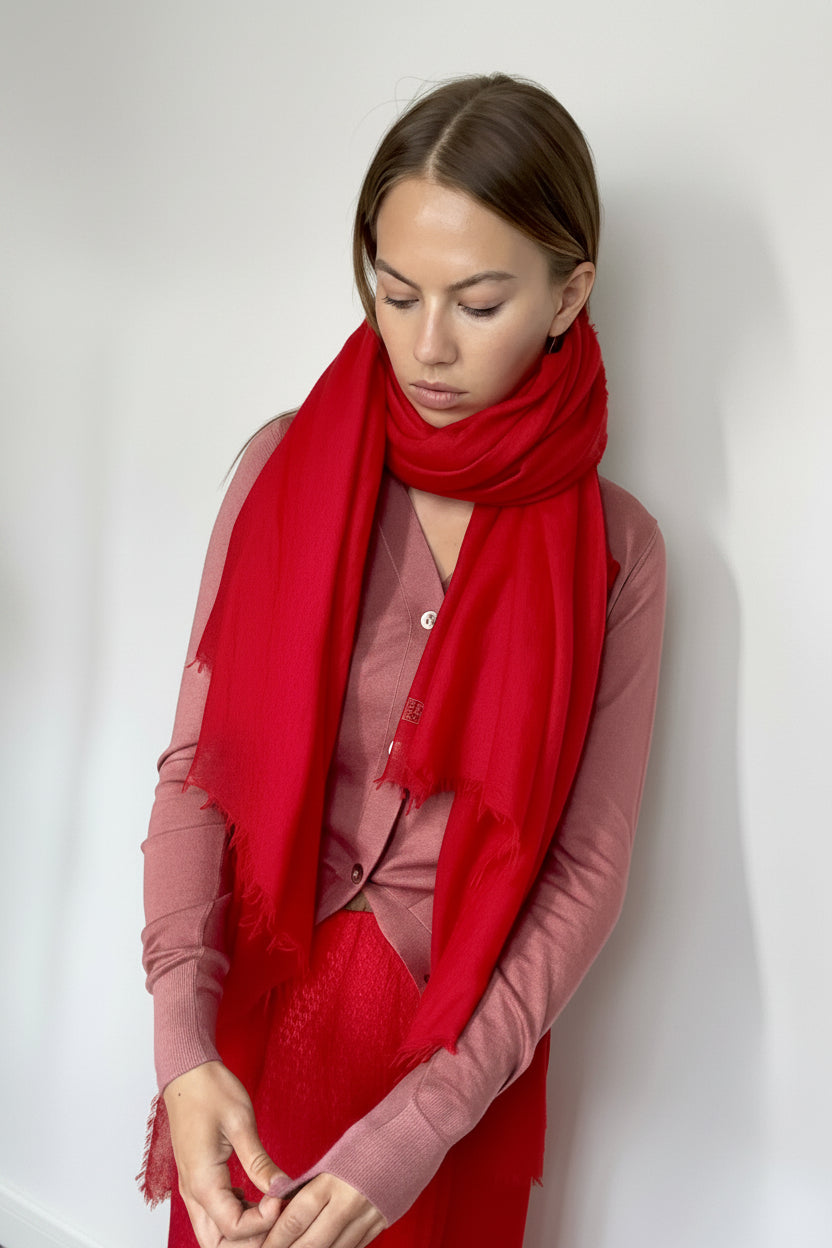 marmee red cashmere scarf and pink cardigan against a white wall