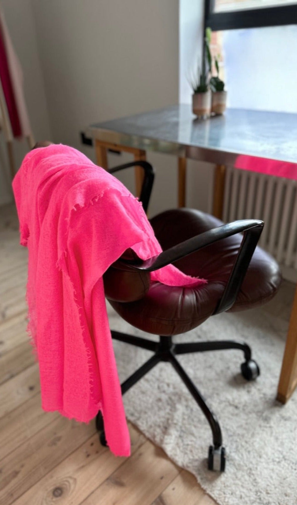 neon pink marmee scarf on a chair