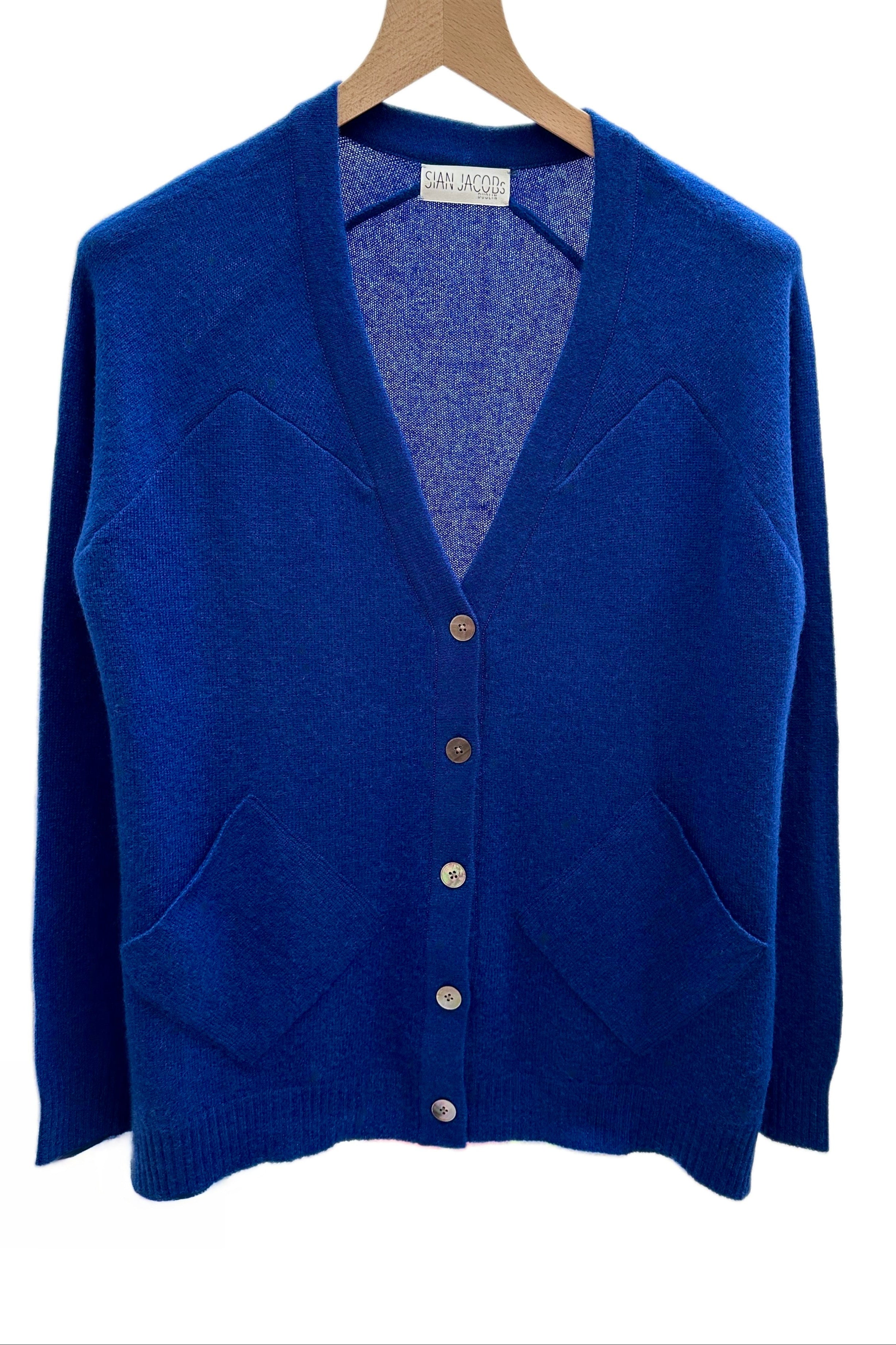 zola french Blue cashmere cardigan on a hanger with a white background