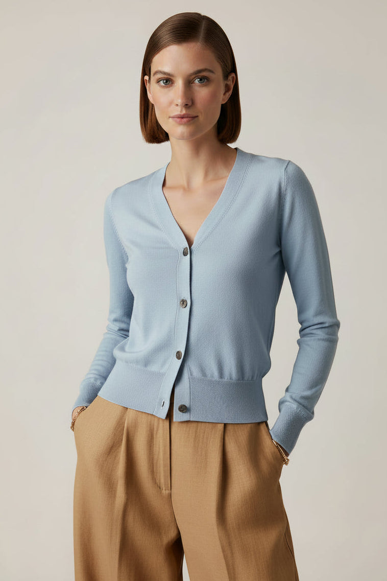 model wearing a light blue cardigan against a plain background