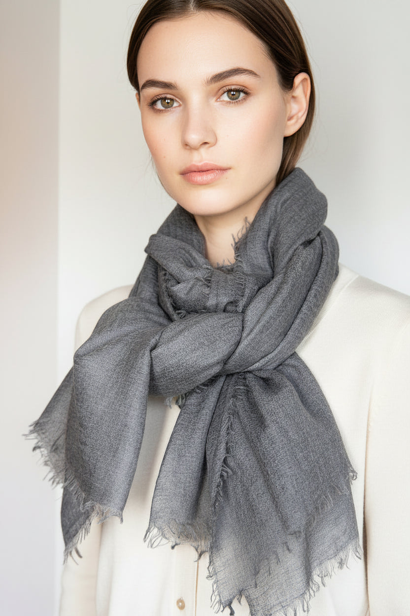 Model wearing a black scarf with a plain background