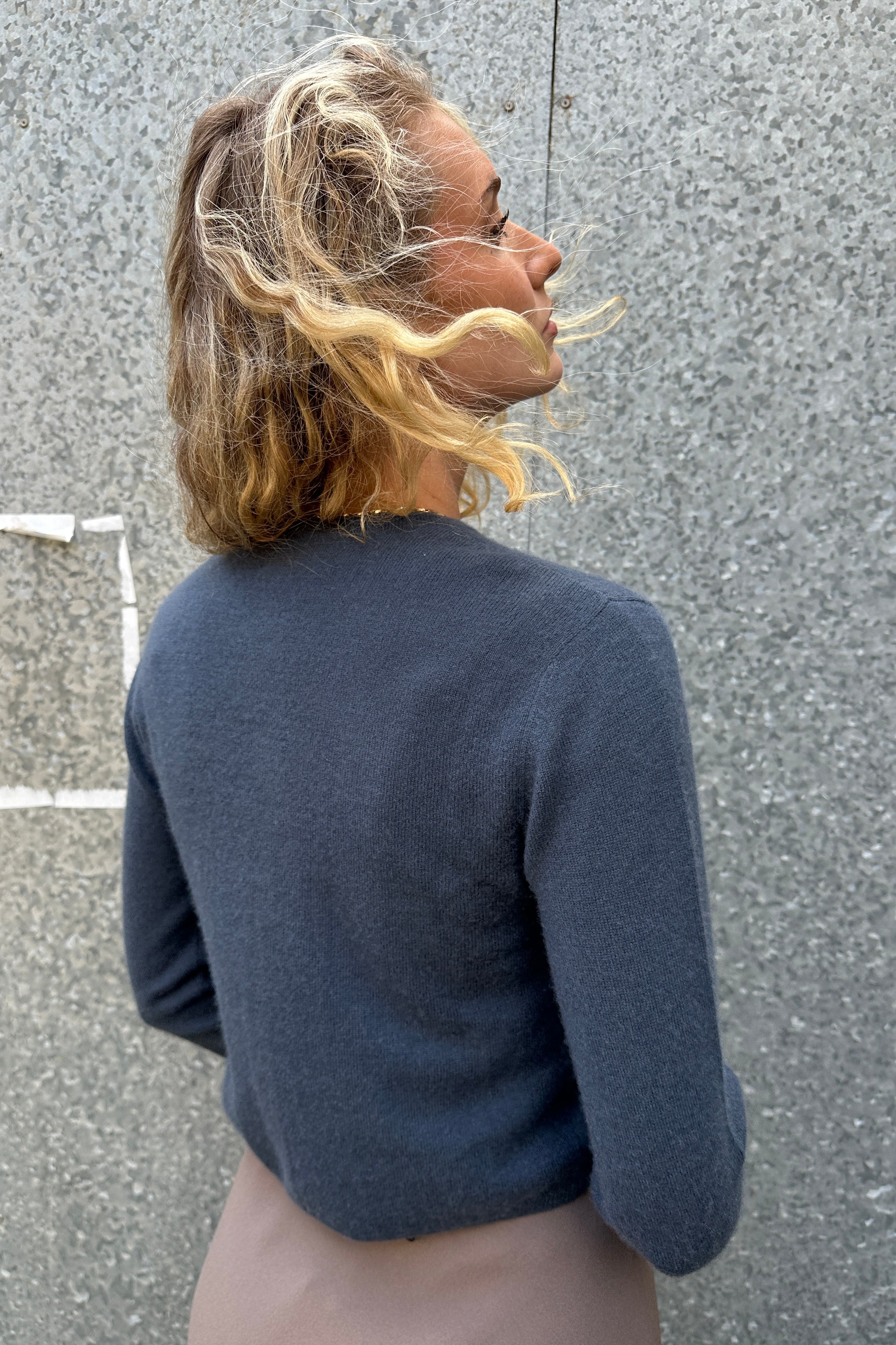 model in Rox grey blue steel cashmere round neck cardigan back view