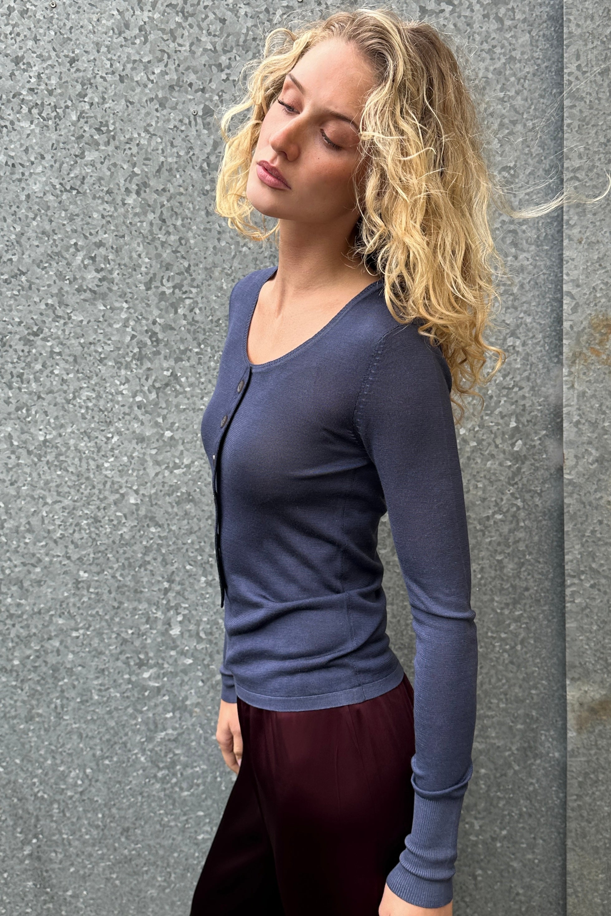 model in bluesy blue scoop button placket silk top side view
