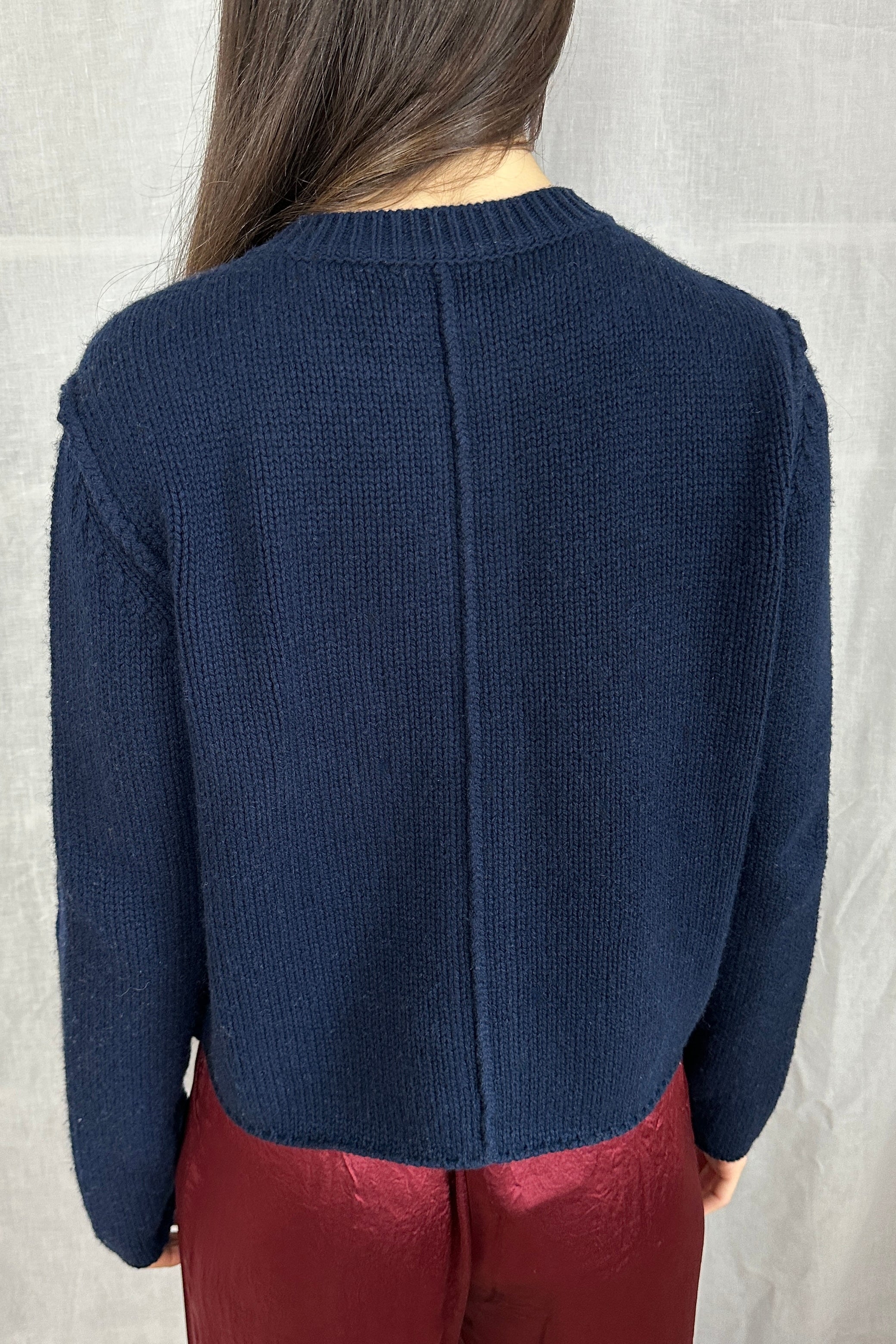 model in janita navy chunky wool mix cardigan back view
