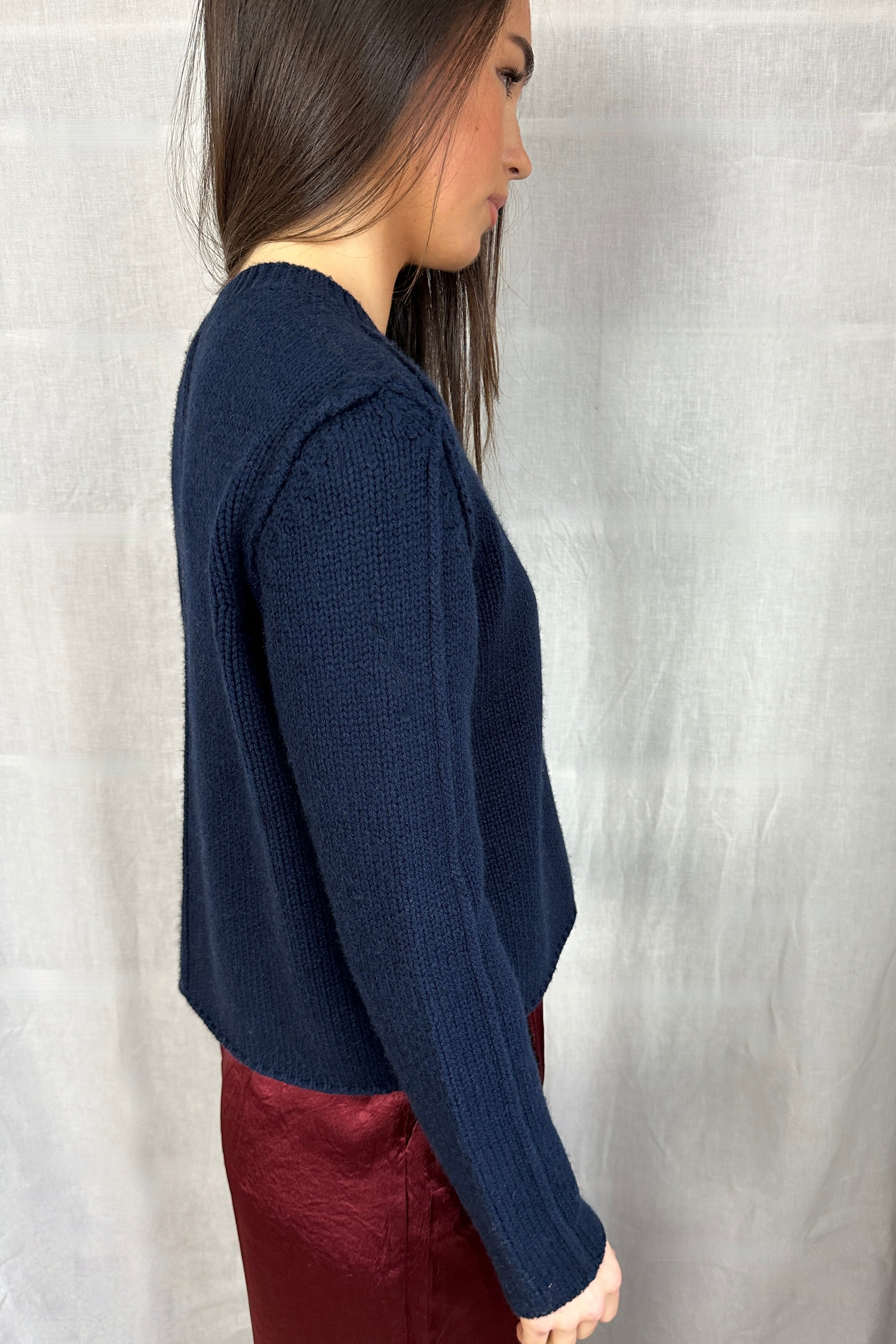 model in janita navy chunky wool mix cardigan side arm view