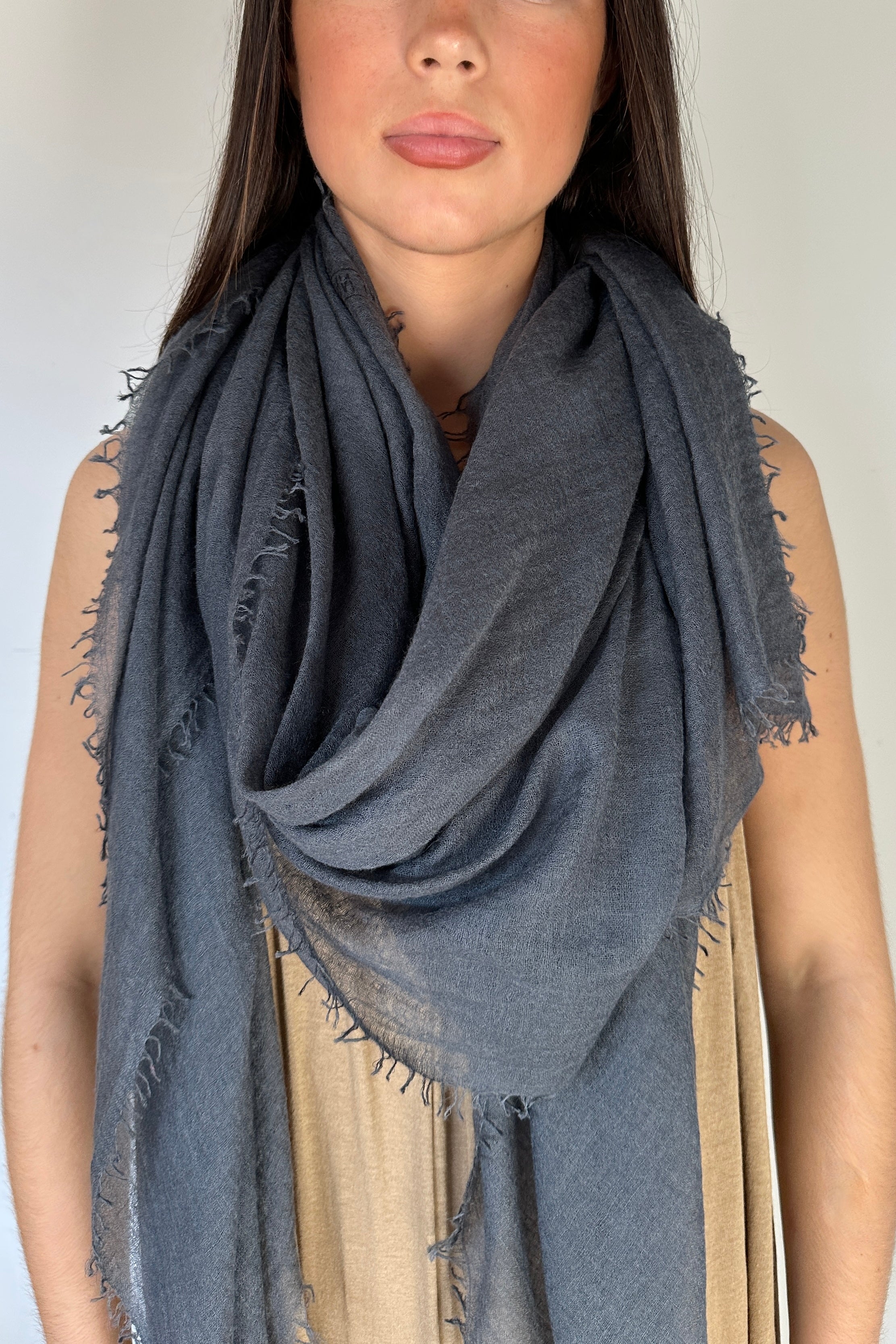 model wearing a dark cashmere marmee petrol gray scarf with a neutral background