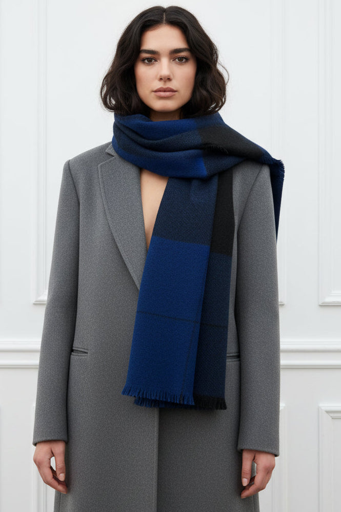 MOdel wearing a blue and black striped scarf against a white background