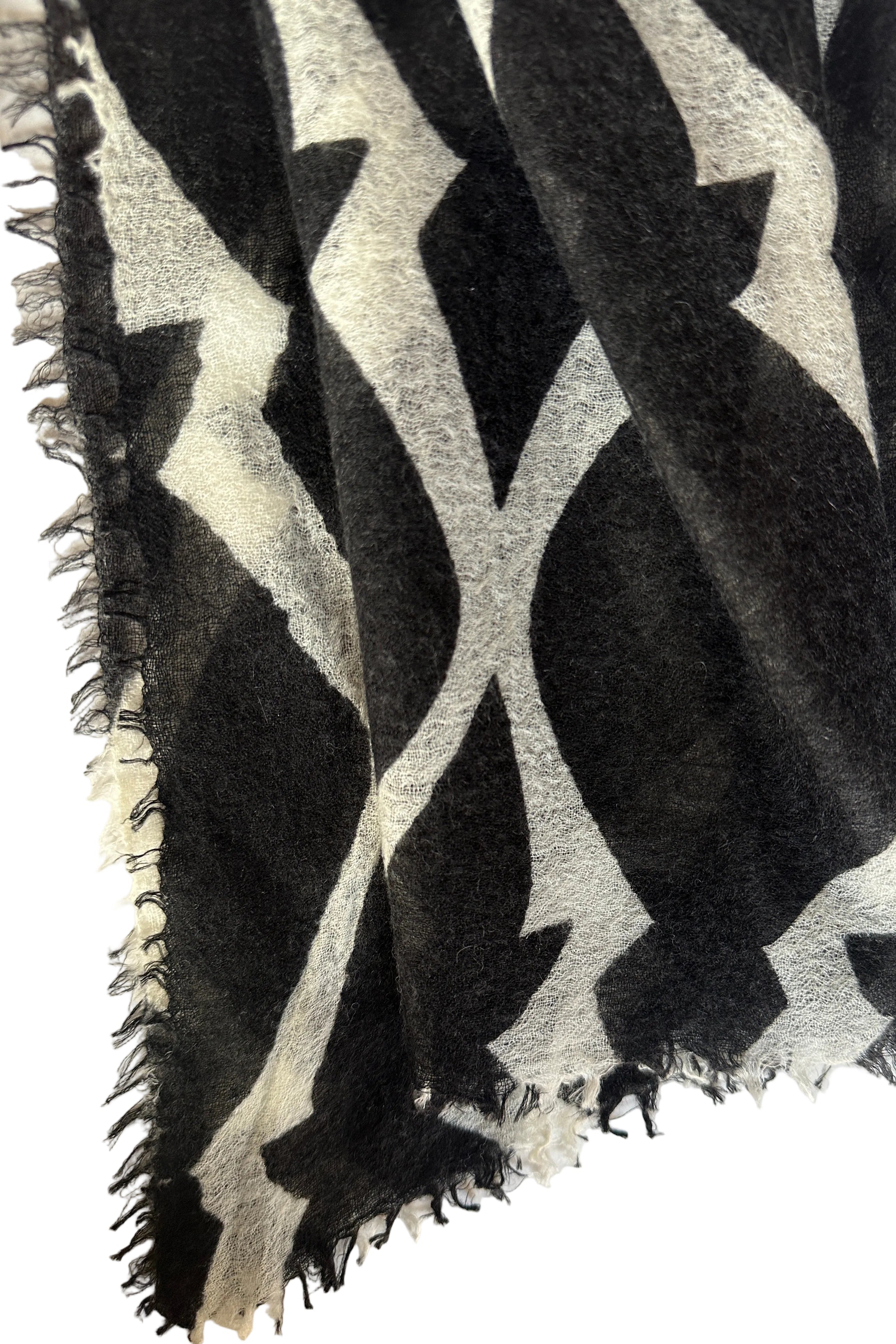 Black and white patterned cashmere scarf on a white surface
