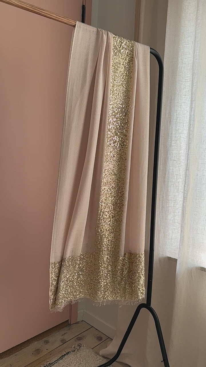 sparkle bare champagne beige scarf with gold sequin details. on rail