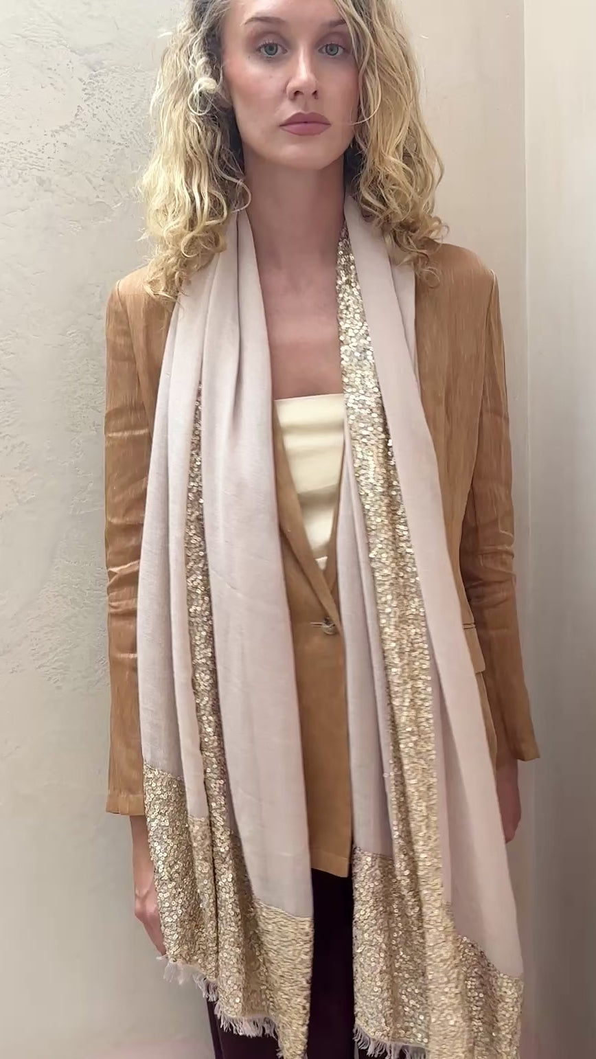 model wearing sparkle bare cashmere champagne beige scarf with gold sequin details.