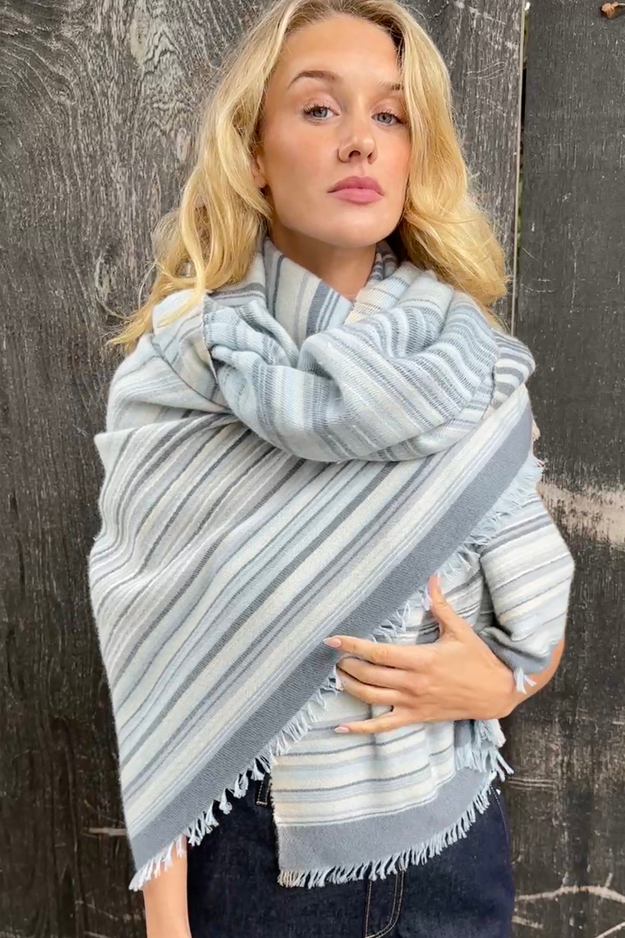 Woman wearing a striped scarf Mizzy stripe blues cream scarf