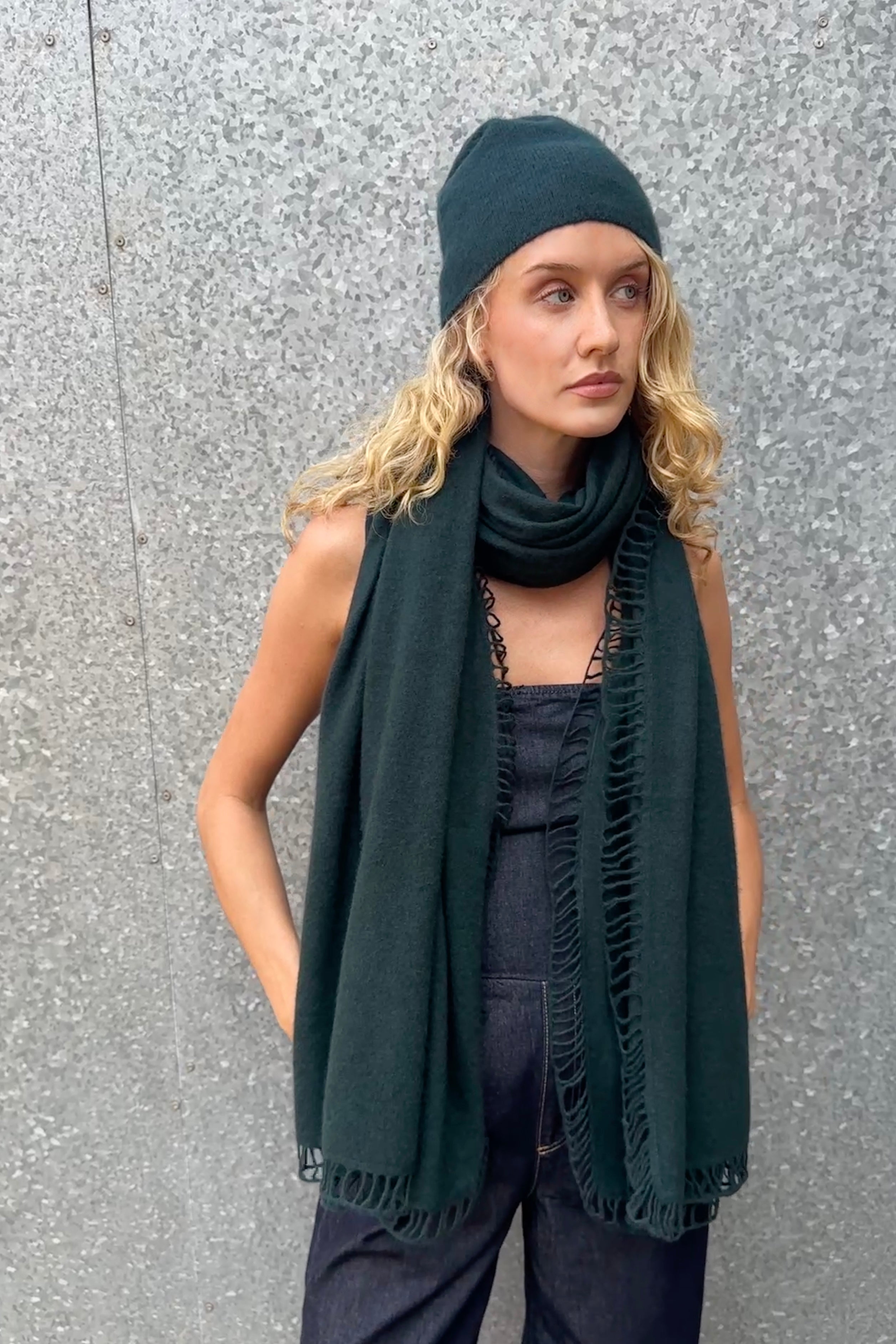 model wearing dark green cashmere scarf and hat