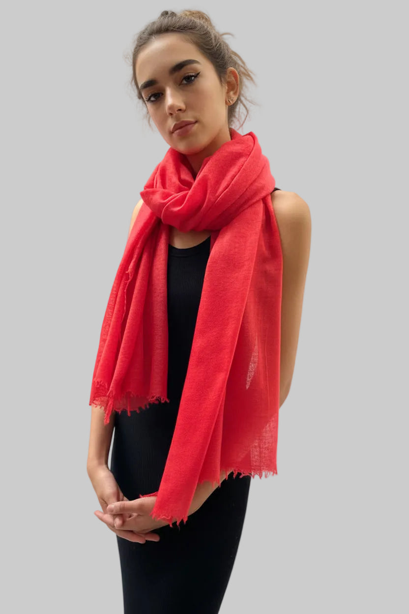 Woman wearing a red scarf on a white background