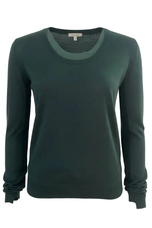 Green sweater on a mannequin against a plain background