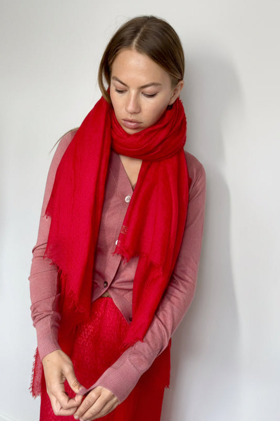 marmee red cashmere scarf and pink cardigan against a white wall