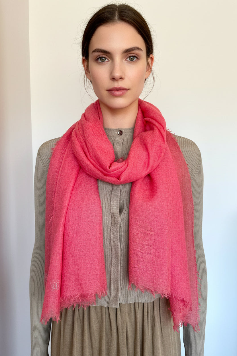 Model wearing a pink scarf with a plain background