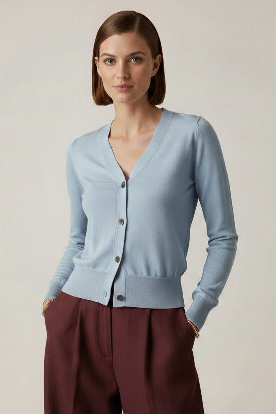 model wearing a light blue cardigan against a plain background