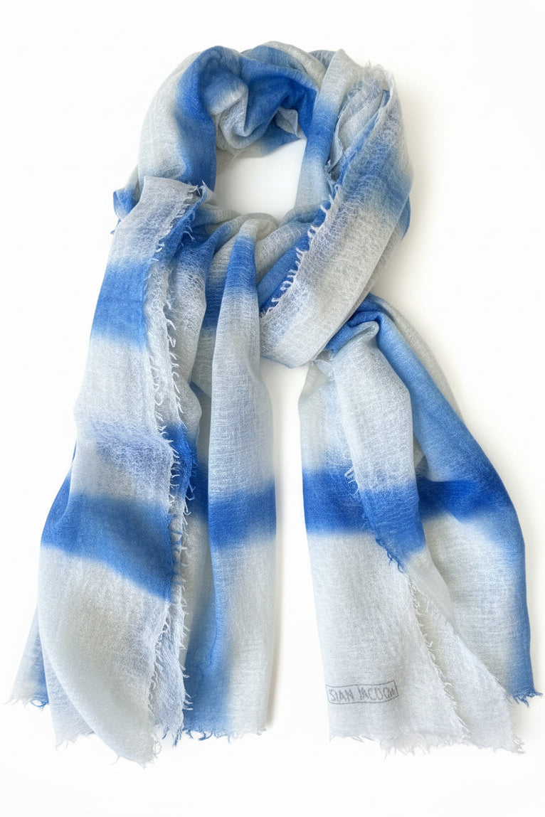 Blue and white striped scarf on a white surface