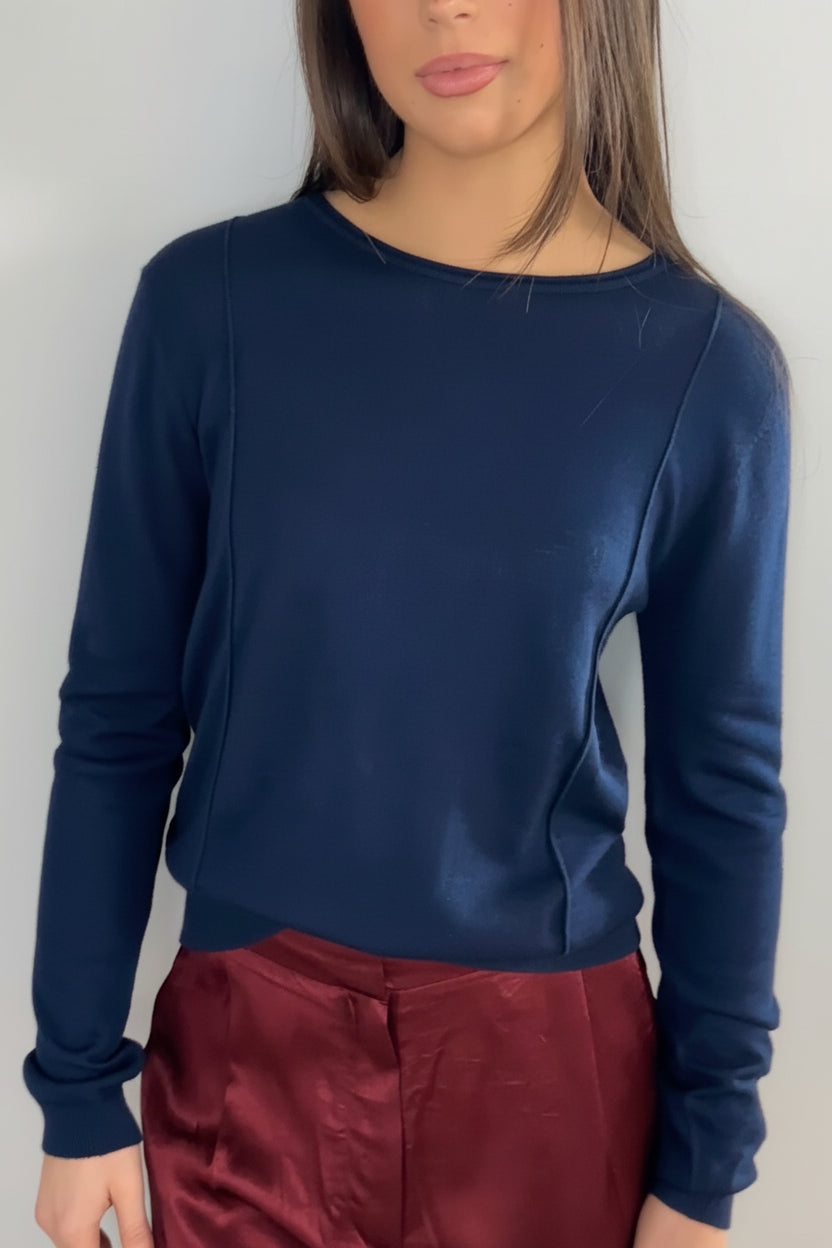 model wearing a navy blue sweater and maroon pants against a plain background Stina navy round neck cashmere silk  top