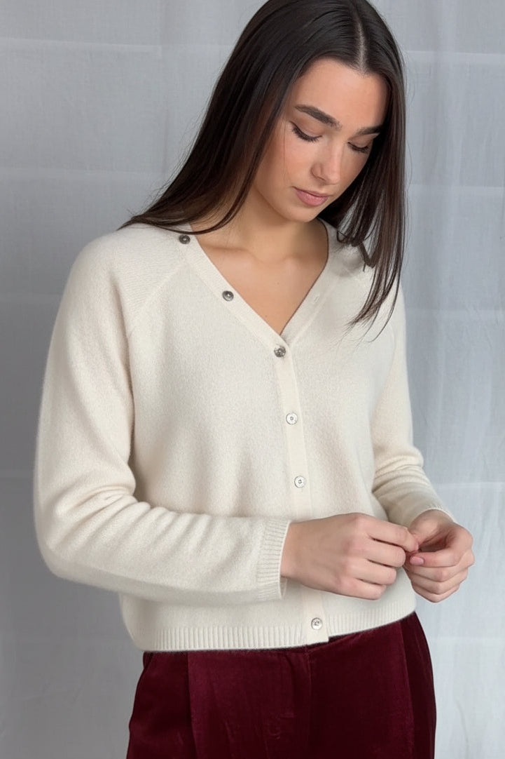 model wearing a cream cashmere cardigan against a plain background ,zelia feather full view