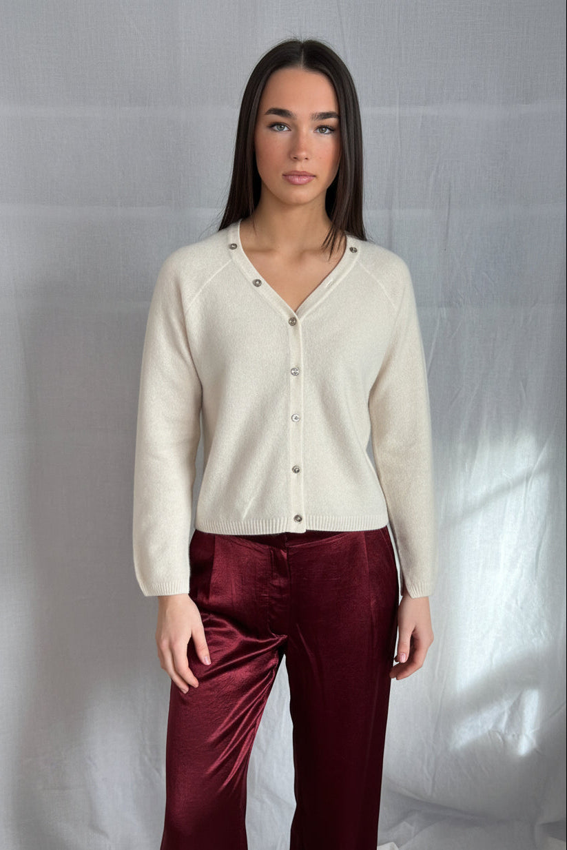 model wearing a cream cashmere cardigan against a plain background ,zelia feather 2