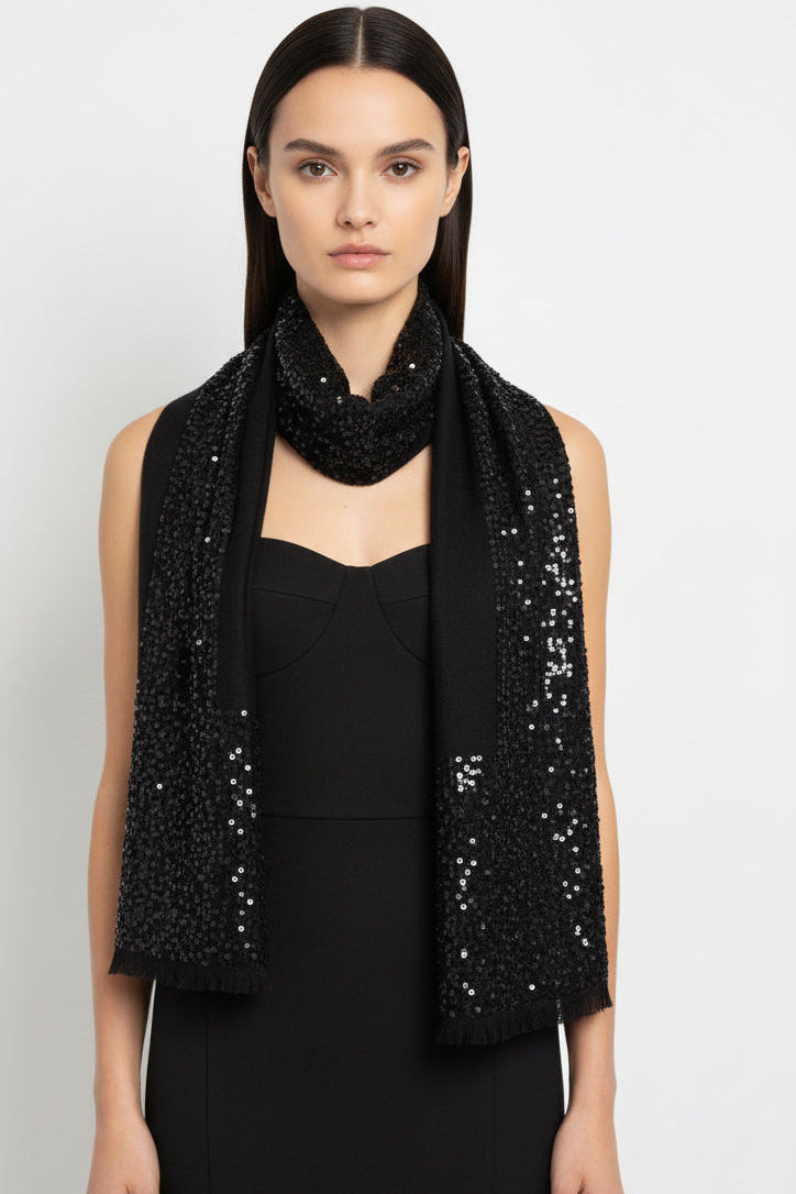 Woman wearing a black sequined scarf on a white background