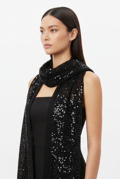 Woman wearing a black sequin scarf on a white background