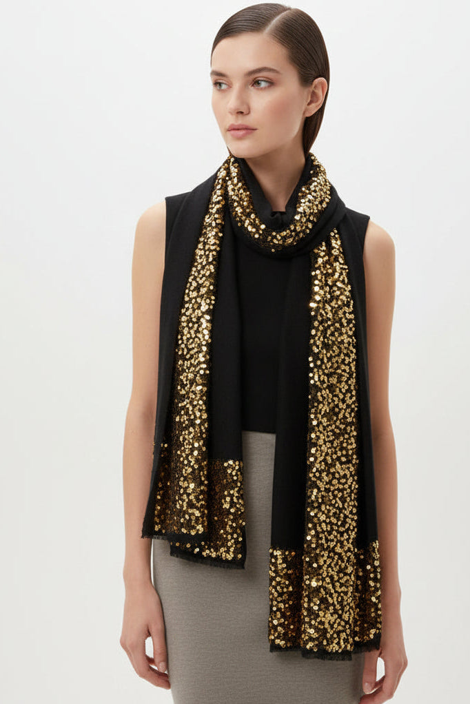 Woman wearing a gold sequin scarf against a white wall