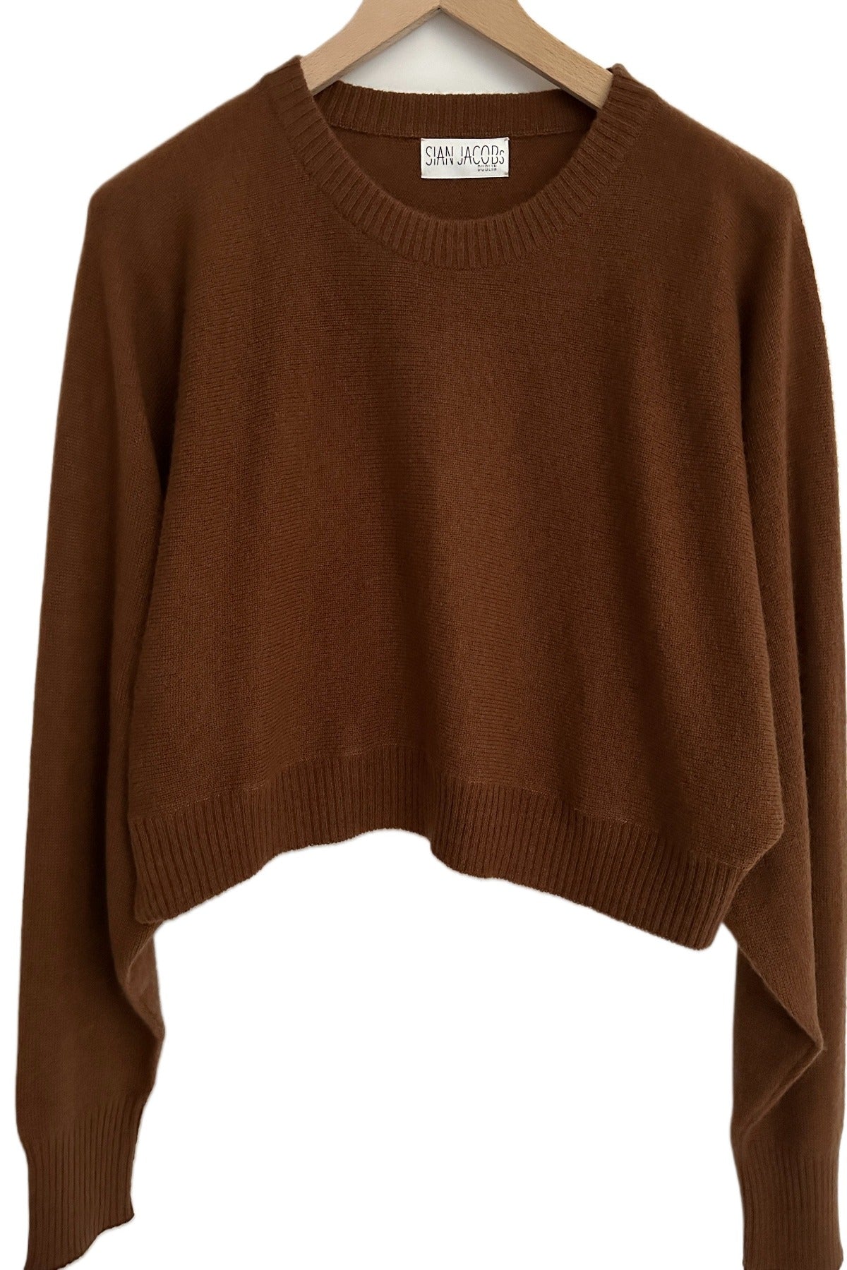 kurt nut brown sweater on hanger