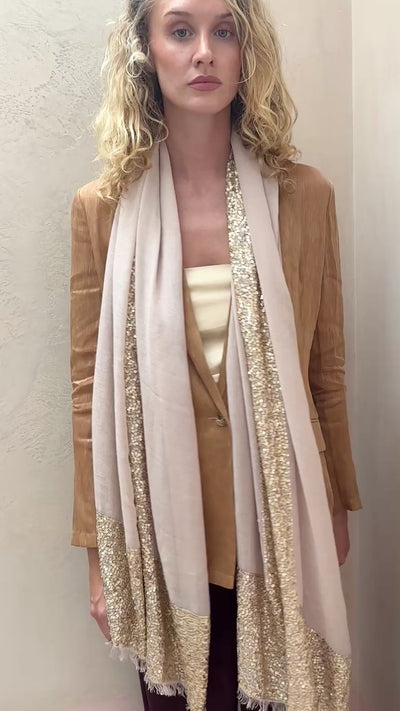  model wearing sparkle bare  cashmere champagne beige scarf with gold sequin details.